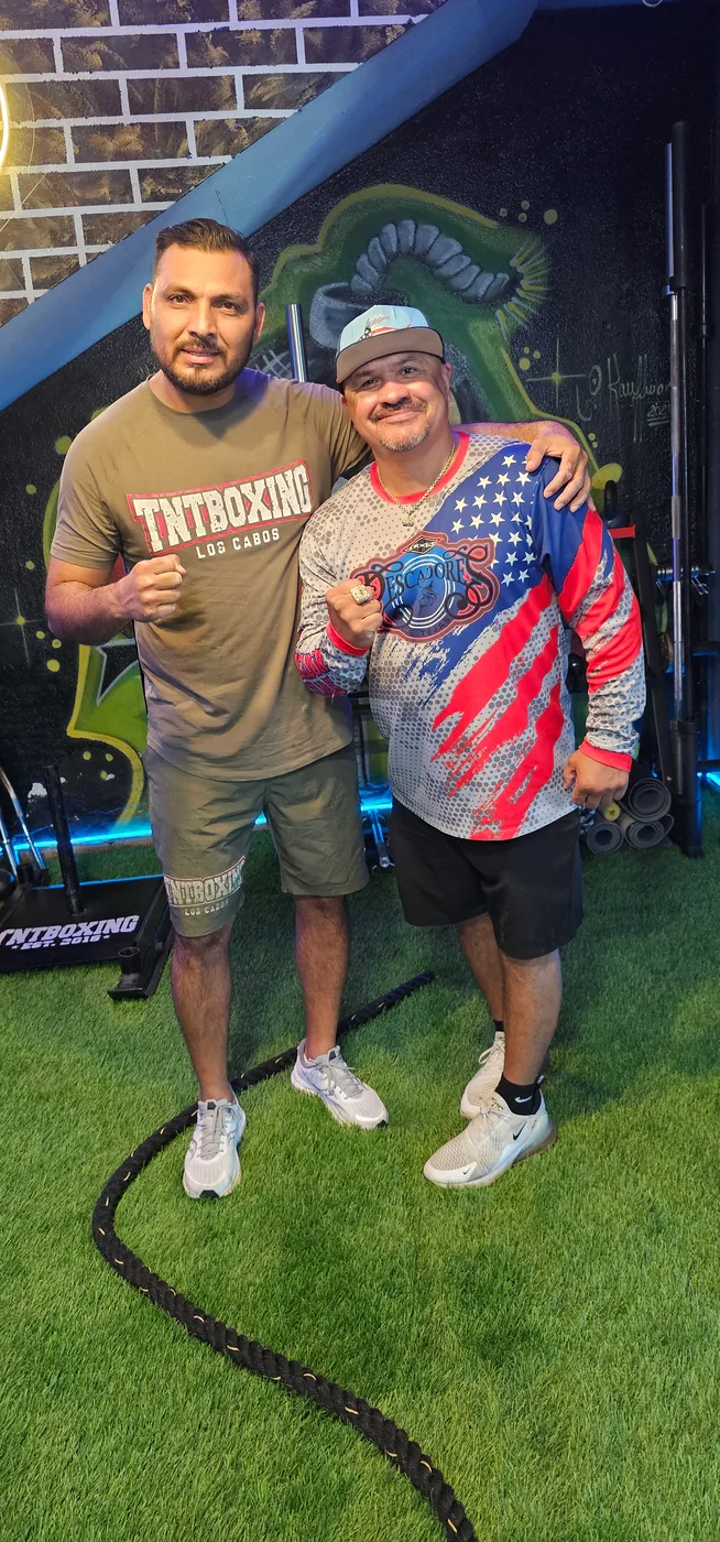 Two members of the TNT community inside the gym
